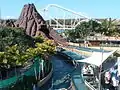 Overview of Bermuda Triangle's station and final drop with the Corkscrew roller coaster in the background.