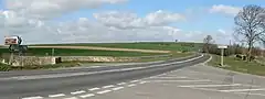 The crossroads in the middle of the parish with the main A162 road running from the distance into the foreground