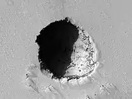 HiRISE image of a 180 m wide lava tube skylight on the volcano's southeast flank