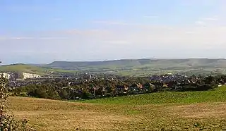 Modern photograph of the site of the Battle of Lewes 1264. The battle was fought between Simon de Montfort and Henry III in the field in the foreground with the former being victorious. Lewes castle and Southerham chalk pits to the left and Beddingham Hill behind it with the town of Lewes.
