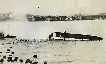 The top-heavily loaded Rodney capsizes and sinks in 1938 with the loss of nineteen lives.